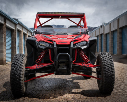 HCR RACING TAL-05400 HONDA TALON 1000R LONG TRAVEL SUSPENSION KIT showcased on a UTV in a storage area.